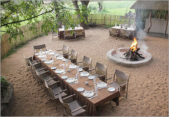 Dining under the night stars alongside a crackling wood fire